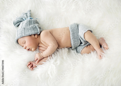 Newborn child sleeping on the blanket photo