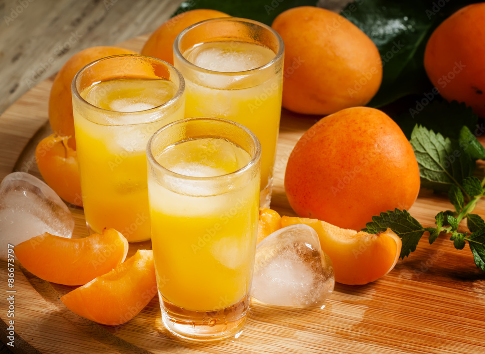 Freshly squeezed apricot juice with ice, selective focus