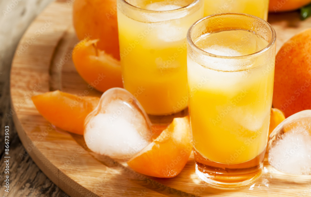 Freshly squeezed apricot juice with ice, selective focus Freshly squeezed apricot juice with ice, selective focus