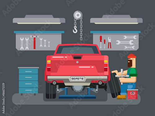 Mechanic Repairs Car in the Garage