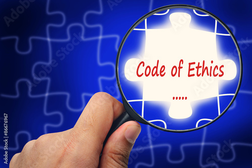 Code of Ethics word. Magnifier and puzzles.