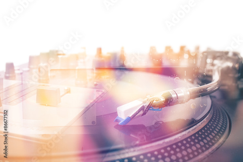 Turntable and vinyl record closeup, double exposure