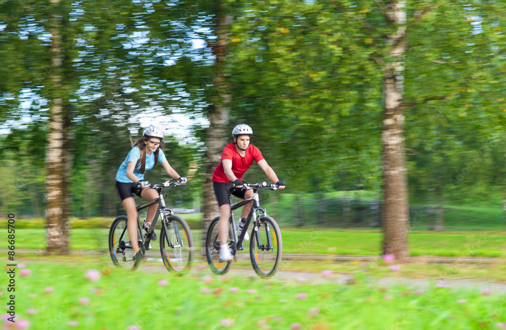 Two Bicycle Riders Having Time Together Outdoors in Summer Fores Two Bicycle Riders Having Time Together Outdoors in Summer Fores