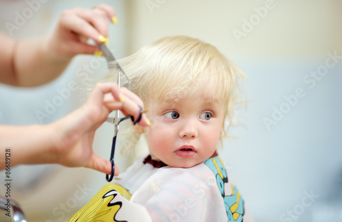Fotografie Toddler child getting his first haircut