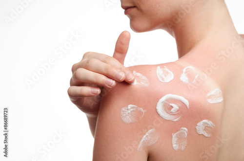 sunblock on the shoulder of a young woman