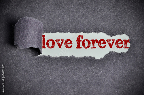 love forever word under torn black sugar paper