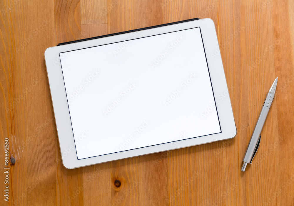Digital Tablet and pen on a desk and presenting a blank screen f Digital Tablet and pen on a desk and presenting a blank screen f