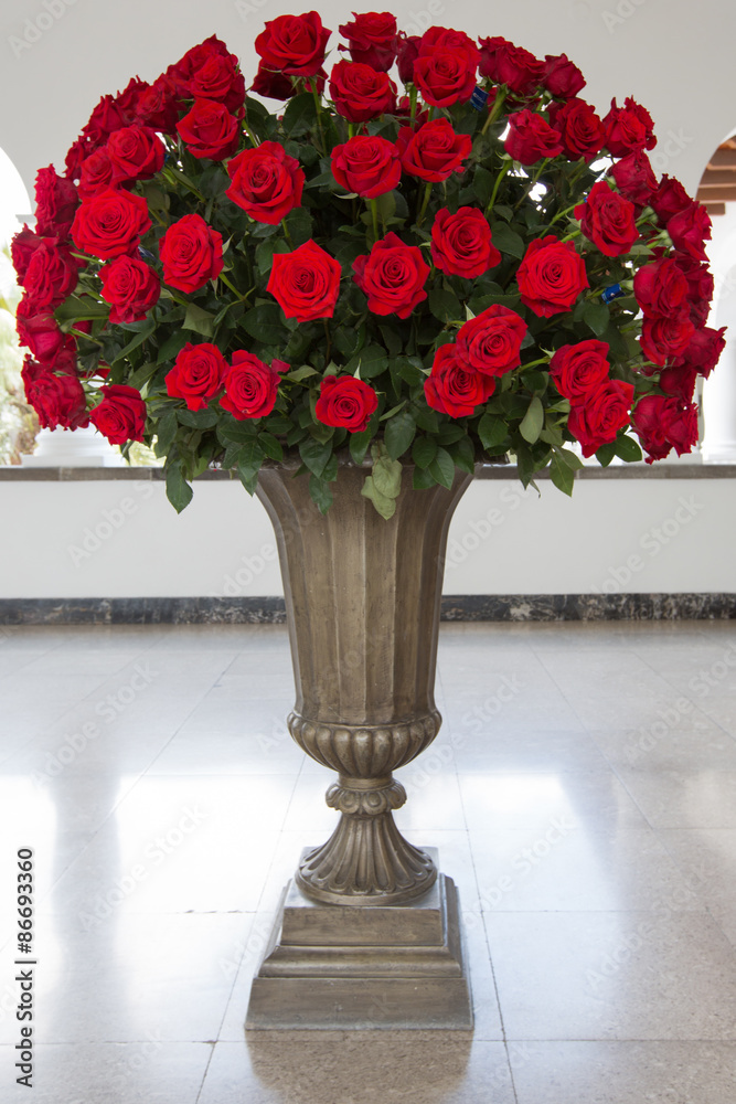 Set of red roses arranged in a stone vase. Quito