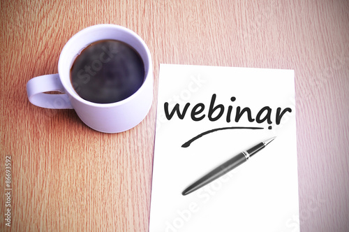 Coffee on the table with note writing webinar