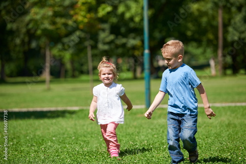 Boy and girl have fun and running in park