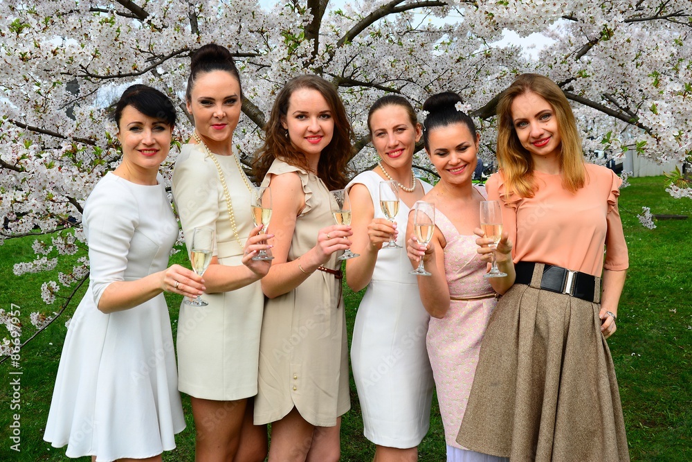 Girls with champagne celebrating in sakura's garden.