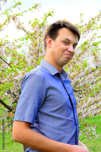 Young boy in the sakura's garden in park
