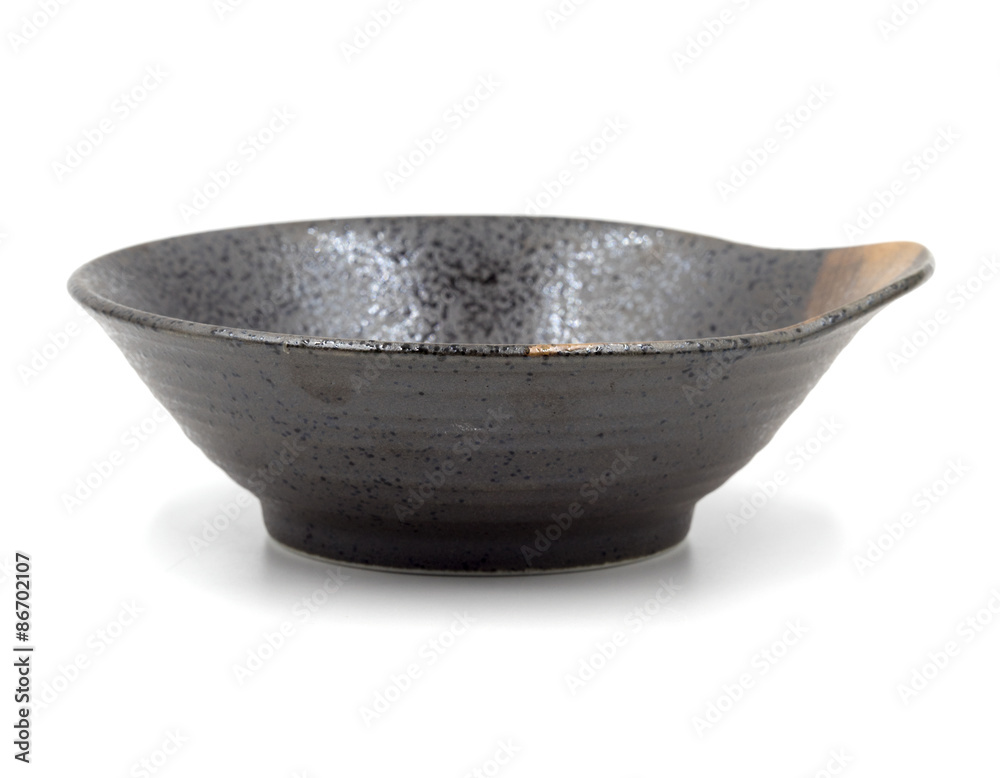 Brown ceramic bowl on a white background. Brown ceramic bowl on a white background.