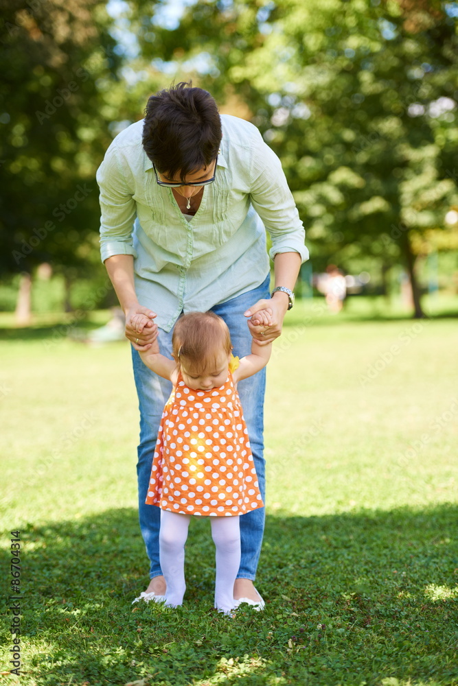 mother and baby in park making first steps mother and baby in park making first steps