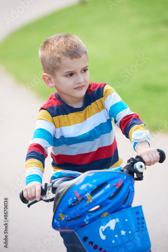 happy boy learning to ride his first bike