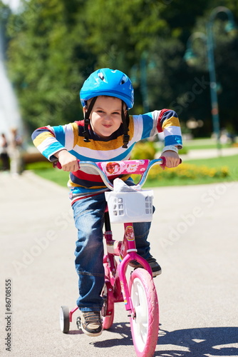 happy boy learning to ride his first bike © .shock