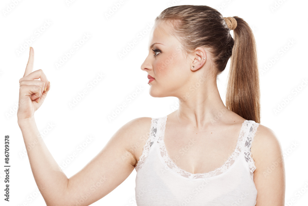 serious young blonde pointing a finger at an imaginary object serious young blonde pointing a finger at an imaginary object