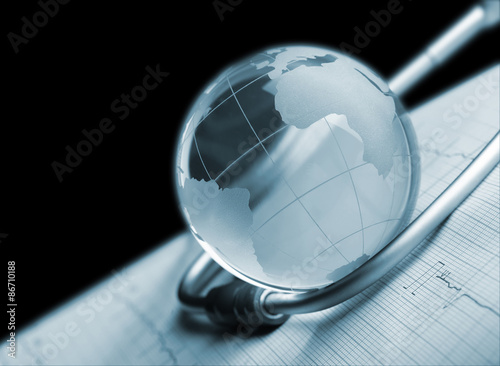Globe and stethoscope on ECG concept