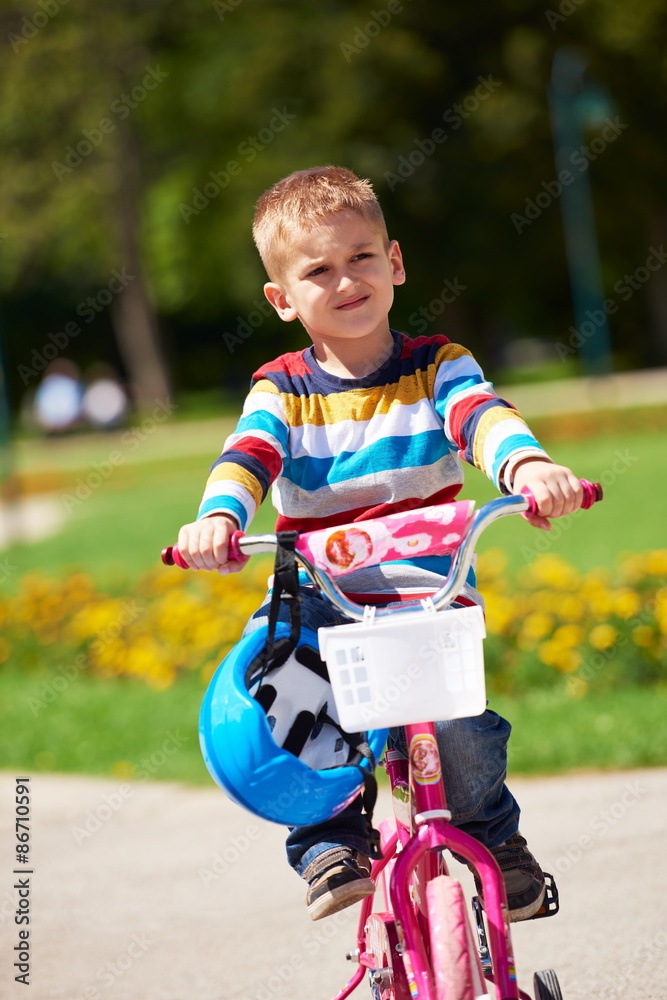 happy boy learning to ride his first bike happy boy learning to ride his first bike