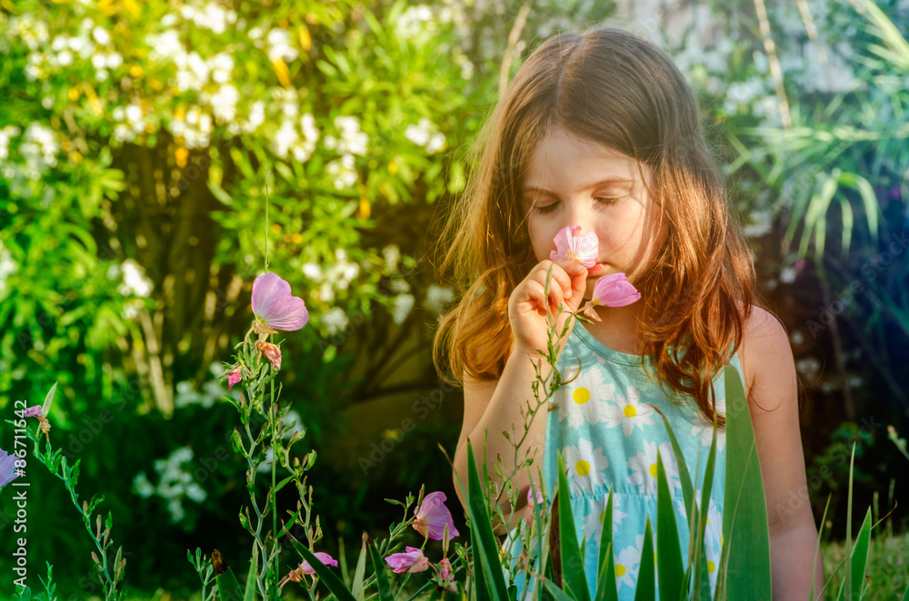 Girl in Exotic Flower Garden Smelling Flowers Girl in Exotic Flower Garden Smelling Flowers