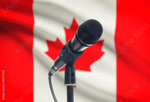 Microphone on stand with national flag on background - Canada