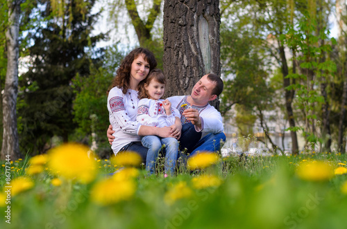 happy Ukrainian family dad mother and daughter on nature