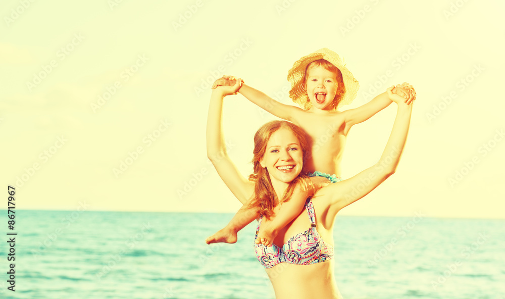 happy family on the beach. mother and baby daughter happy family on the beach. mother and baby daughter