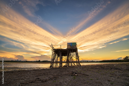 Abandon wooden fisherman hut in beautiful sunset scene