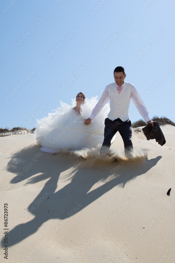 Beautiful wedding couple at the beach with wedding dress Beautiful wedding couple at the beach with wedding dress