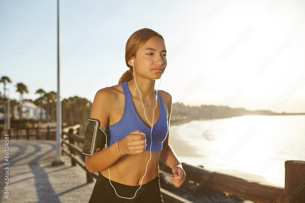 Young female running outside at dawn Young female running outside at dawn