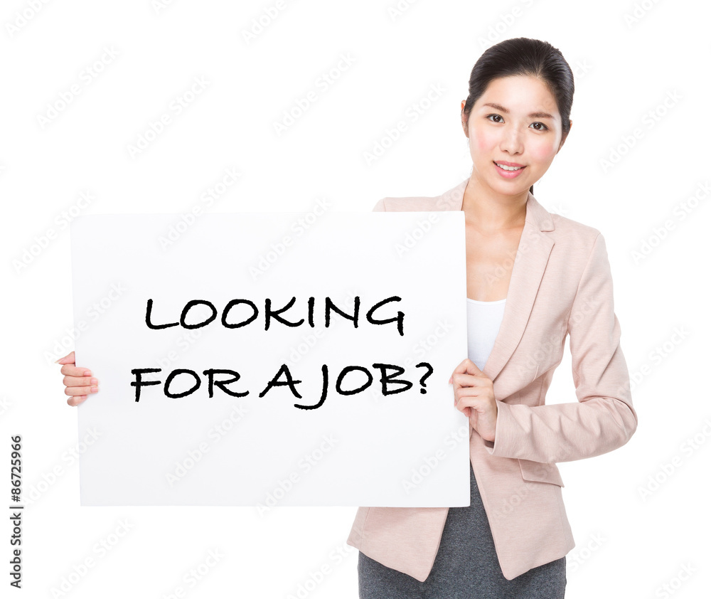 Businesswoman holding a placard showing phrase of looking for a Businesswoman holding a placard showing phrase of looking for a