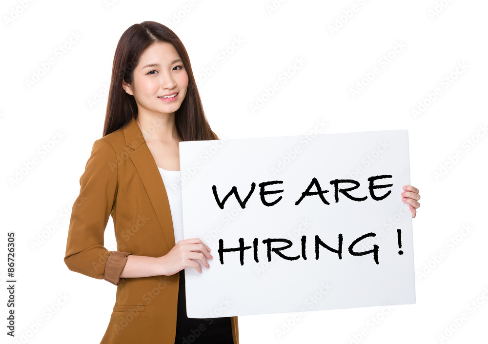 Businesswoman hold with palcard and presenting phrase of we are Businesswoman hold with palcard and presenting phrase of we are