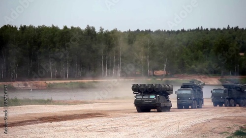 Military tanks driving along the road, Russian military convoy
