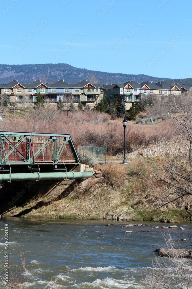 Line of condos above the Animas River and a bridge in Durango, CO