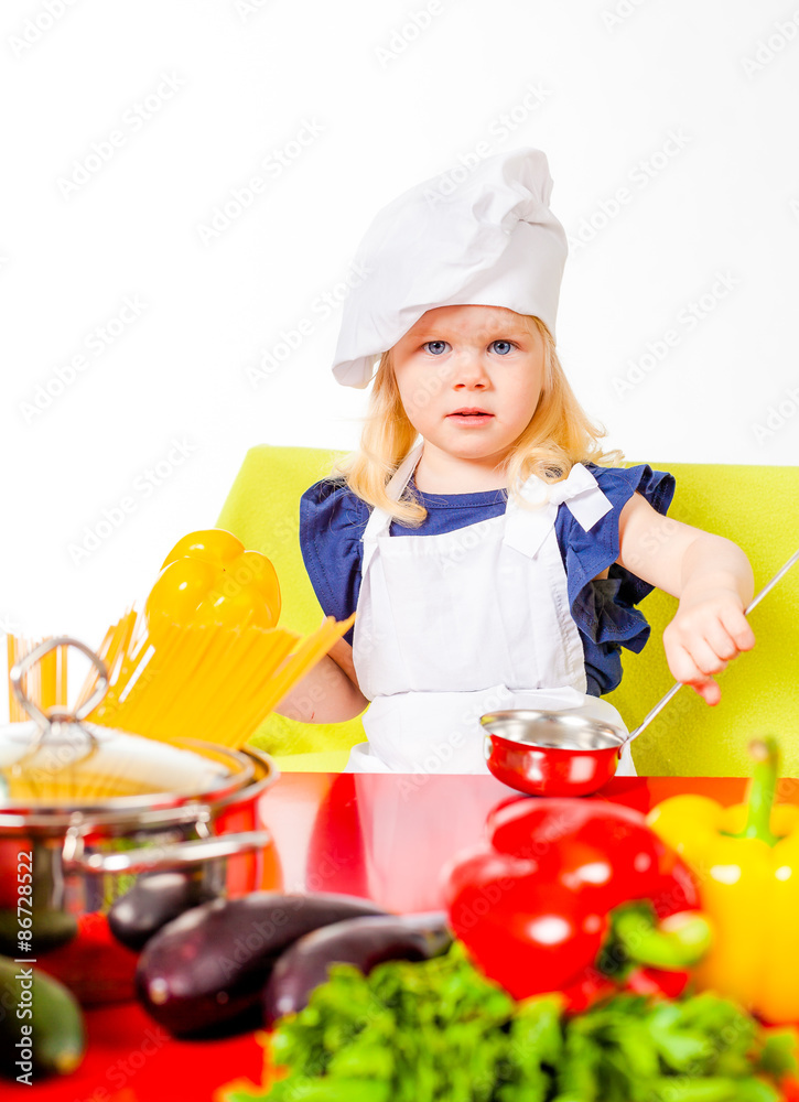 Cute girl holding kitchen spoon in hand Cute girl holding kitchen spoon in hand