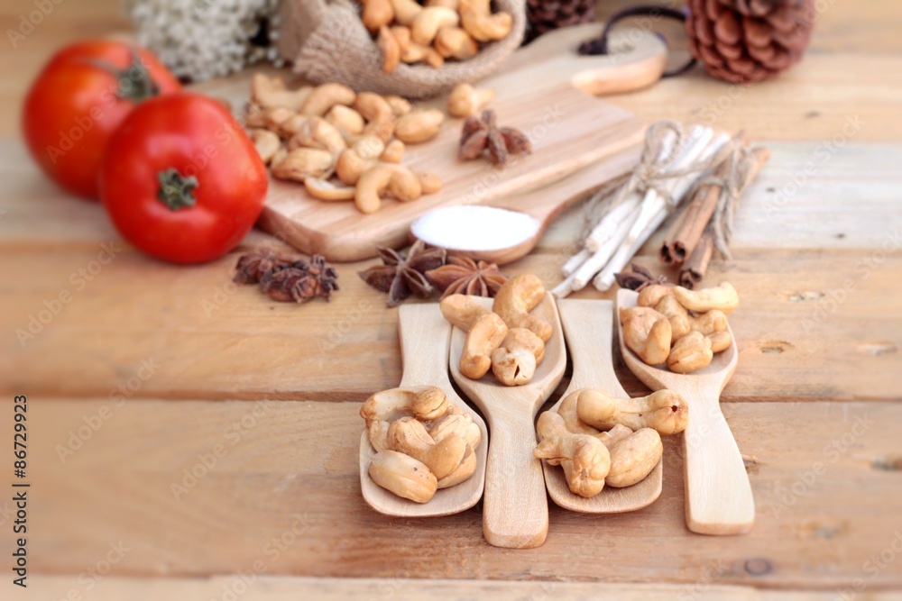 Roasted cashews nuts with natural on wood background