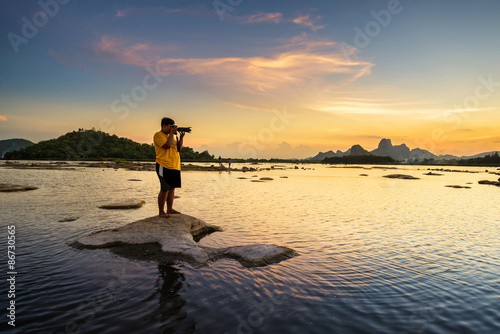 Photographer take a picture of beautiful sunset in lake © martinhosmat083