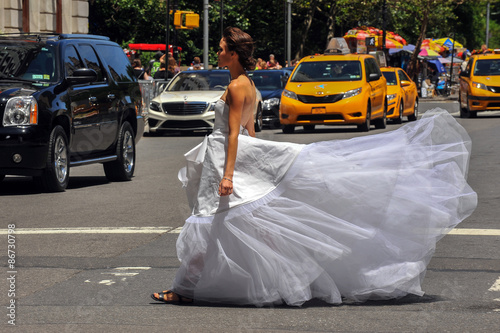 Model Kalyn Hemphill crossing the street in front of Plaza hotel at the Irina Shabayeva SS 2016 Bridal collection photo shoot. photo