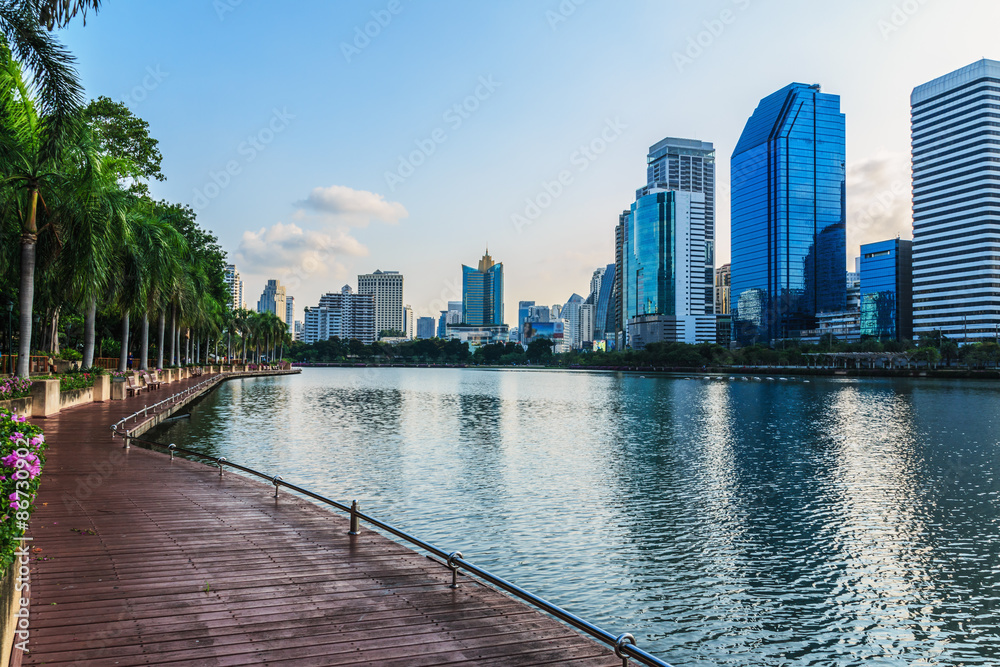 The landscape urban park with water and buildings in Bangkok.
