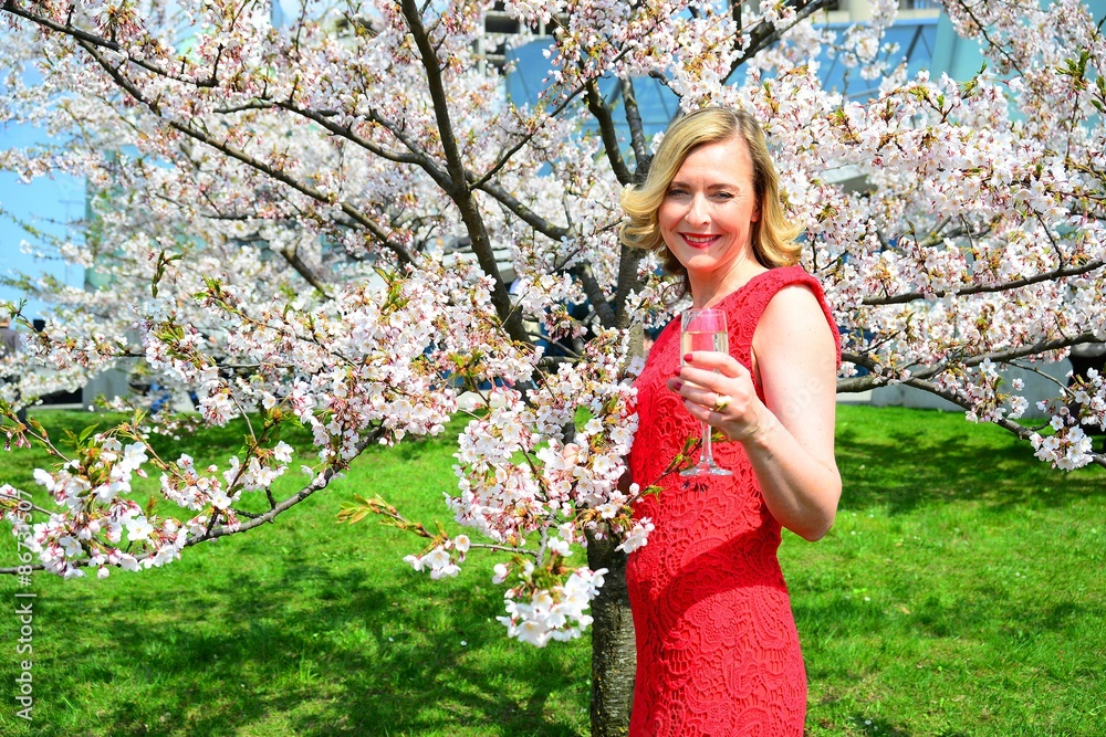 Beautiful female posing in the sakura garden