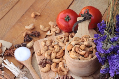 Roasted cashews nuts with natural on wood background