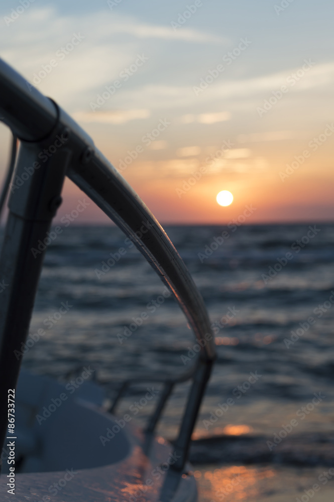 handrail of a powerboat against sunset handrail of a powerboat against sunset
