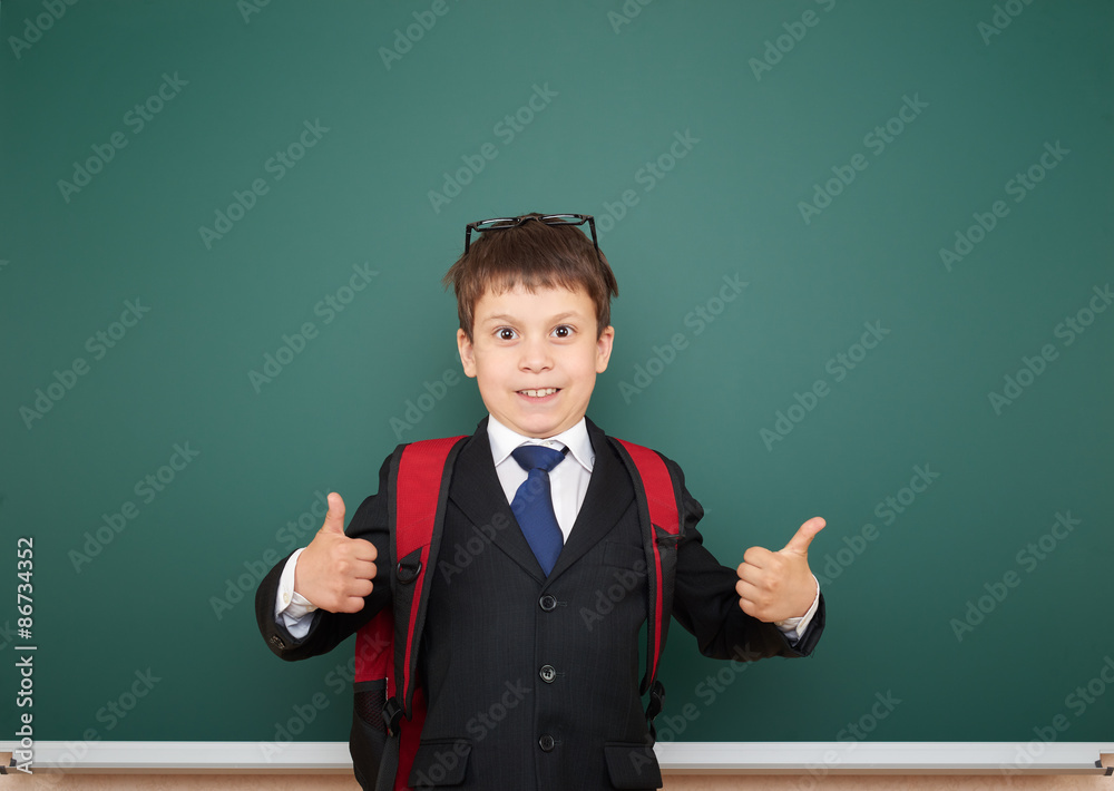 Schoolboy with backpack on school board background Schoolboy with backpack on school board background