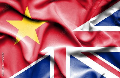 Waving flag of United Kingdom and Vietnam