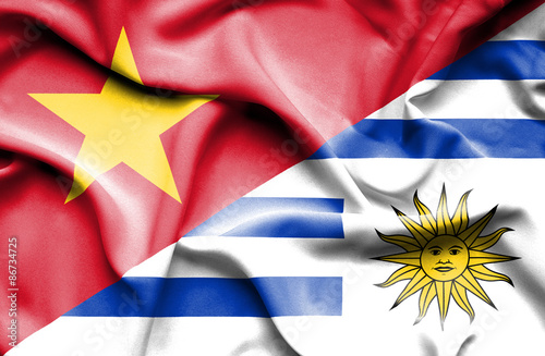 Waving flag of Uruguay and Vietnam