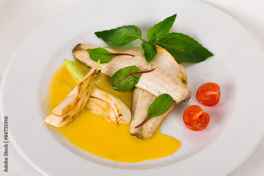 beautiful flow of white fish fillet with beetroot leaves and