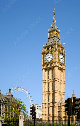 The iconic Big Ben clock tower rising over the Houses of Parliament by the banks of the River Thames in London, England.
