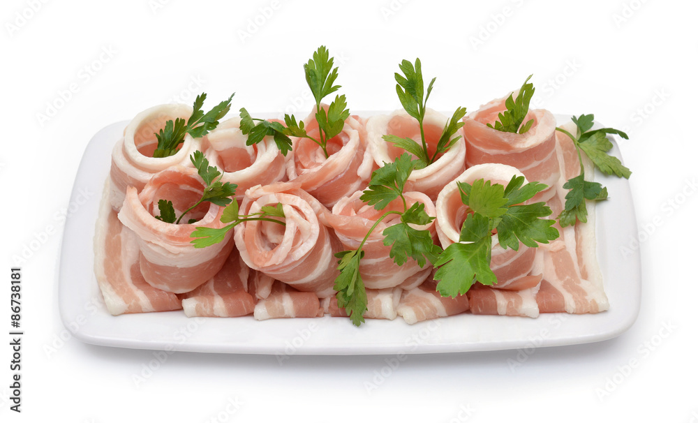 Rolled bacon with parsley isolated on white. Top view