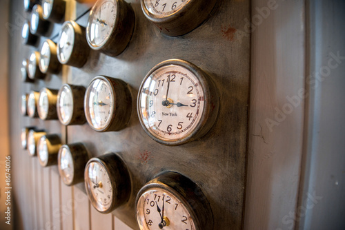 Metal wall with old styled clocks