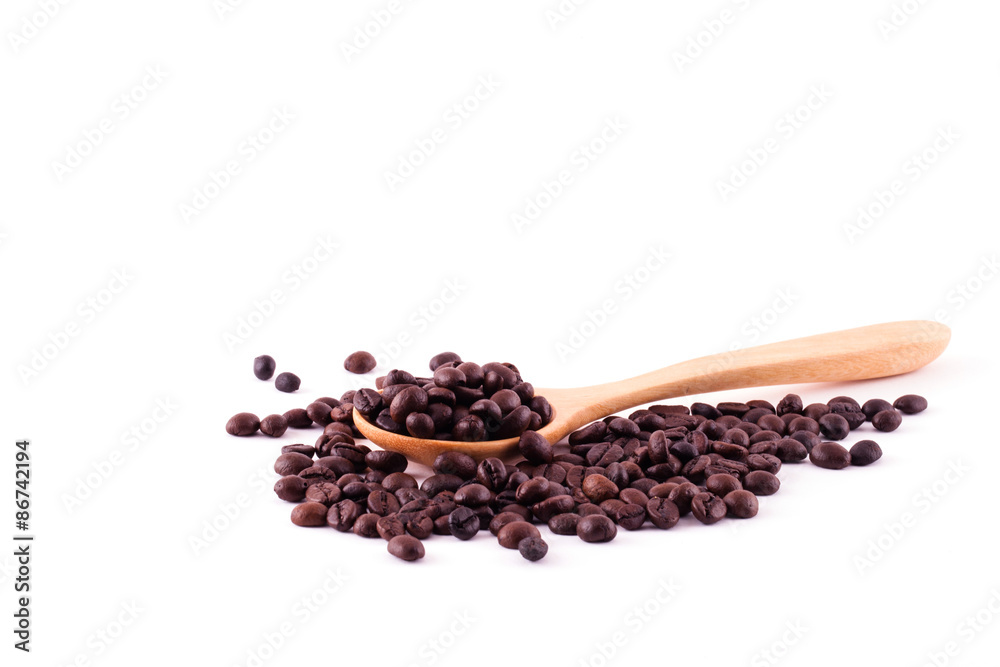 Spread coffee seeds on wooden spoon isolated on white background Spread coffee seeds on wooden spoon isolated on white background